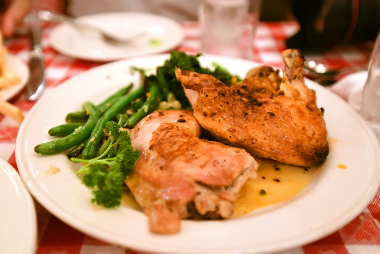 chicken, broccoli and a side dish on a plate