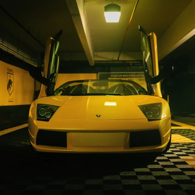 a yellow car is parked in a parking lot