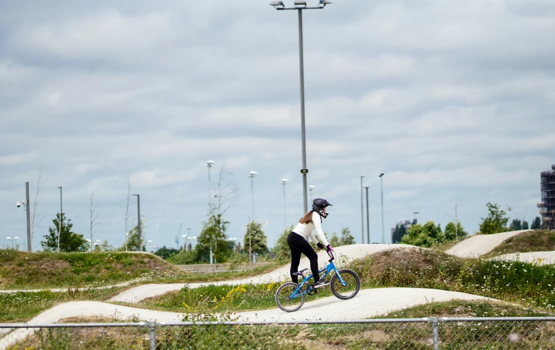 a person on a bike is near mounds of dirt