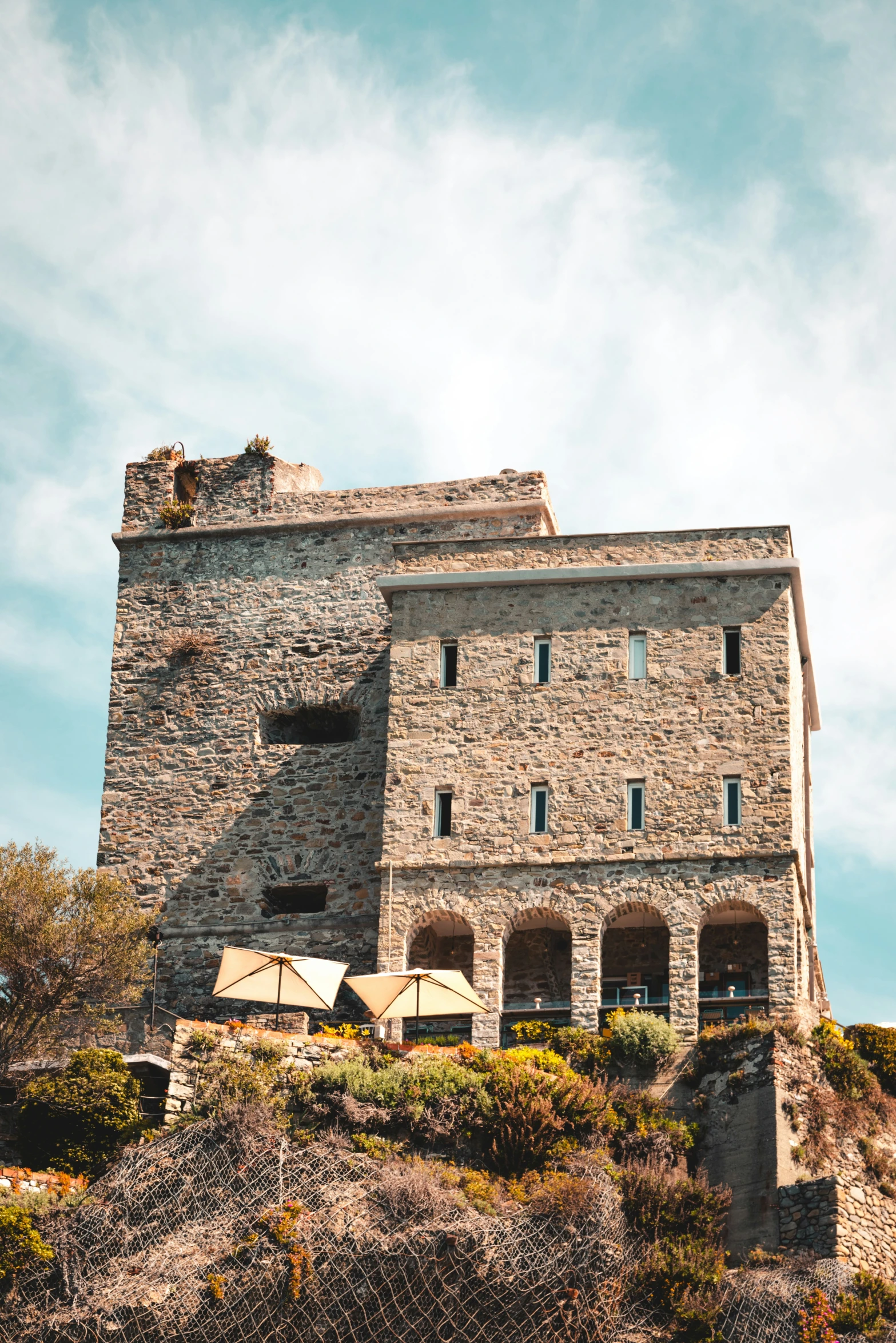 an old stone building sitting on top of a mountain