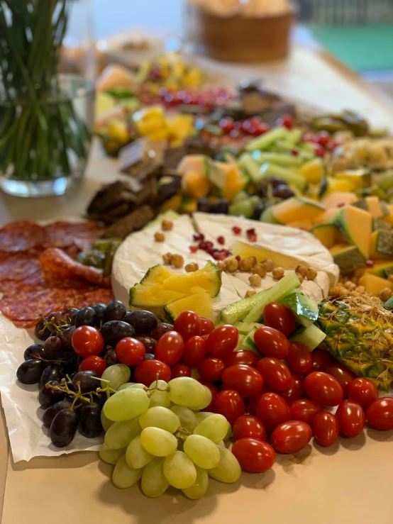 a bunch of different kinds of food are arranged on the table