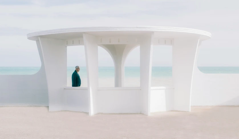 there is a man standing inside a white structure