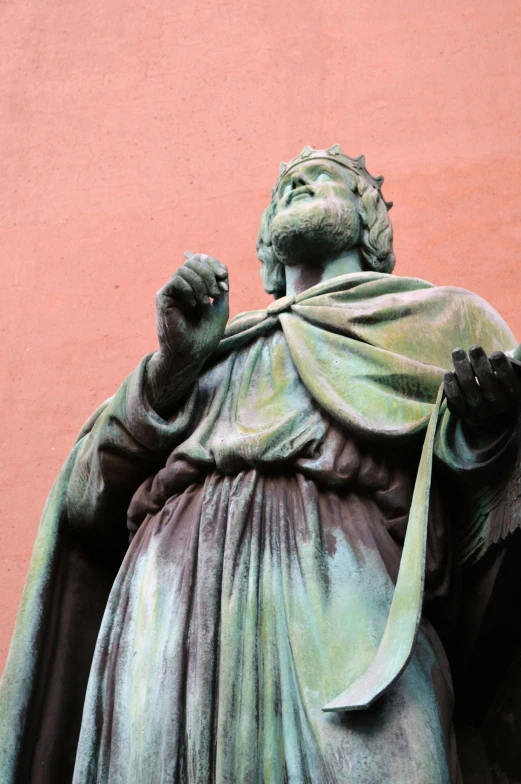 a bronze statue standing with a sword up in his hand