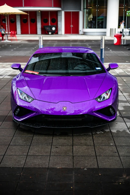 a very big beautiful car that is purple in color