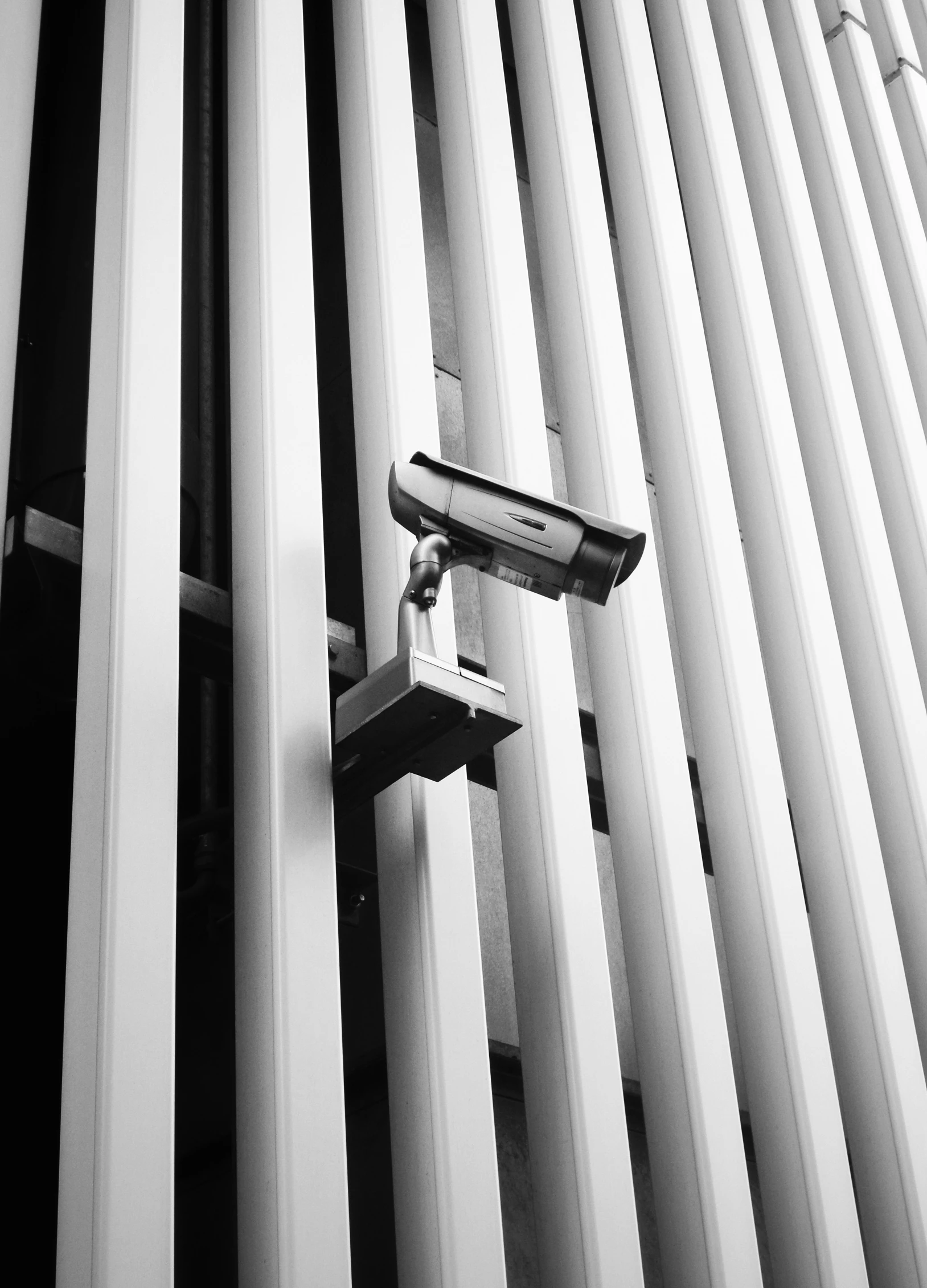 a security camera on a white building