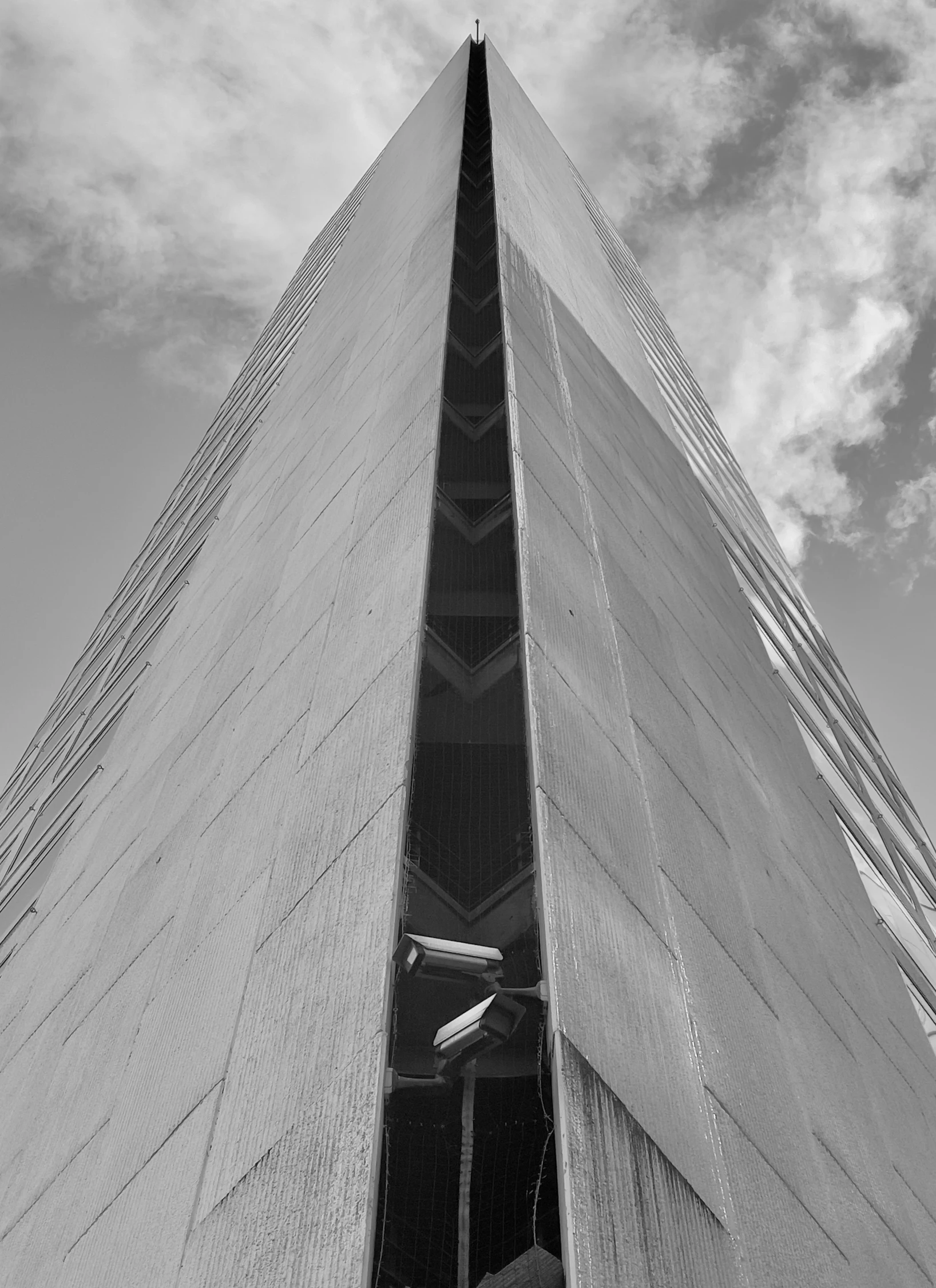 looking up at the tall structure with a sky background