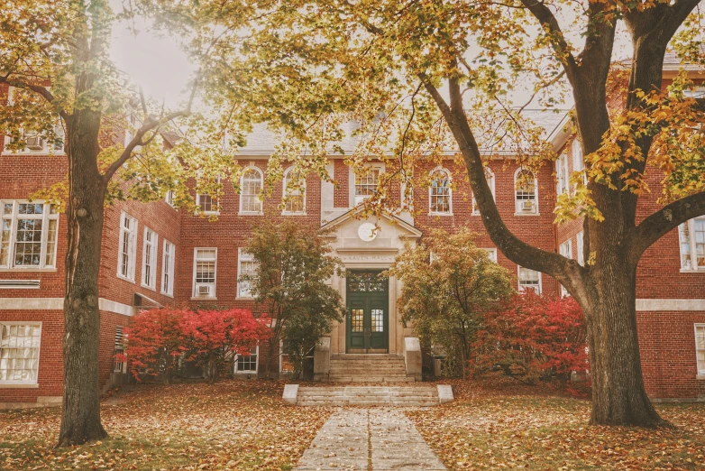 an old red brick building surrounded by trees