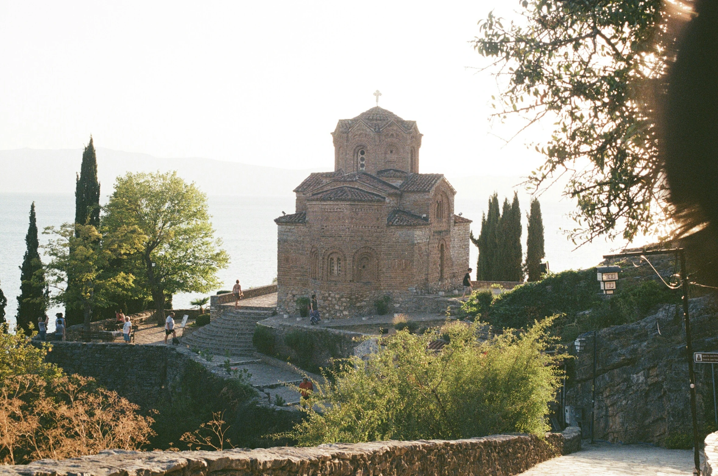 a stone church with trees in front of it