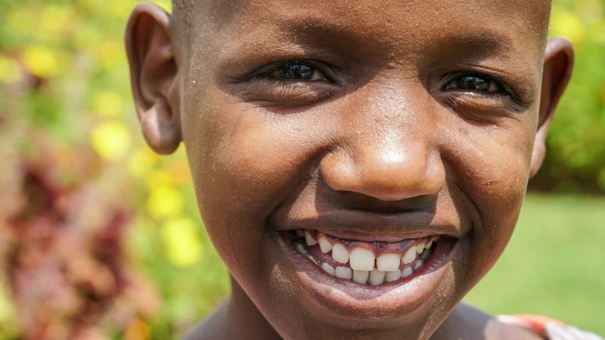 a close - up of a child's teeth with dirt on it