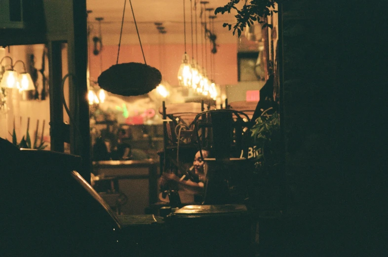 a small shop with several hanging lights and chairs