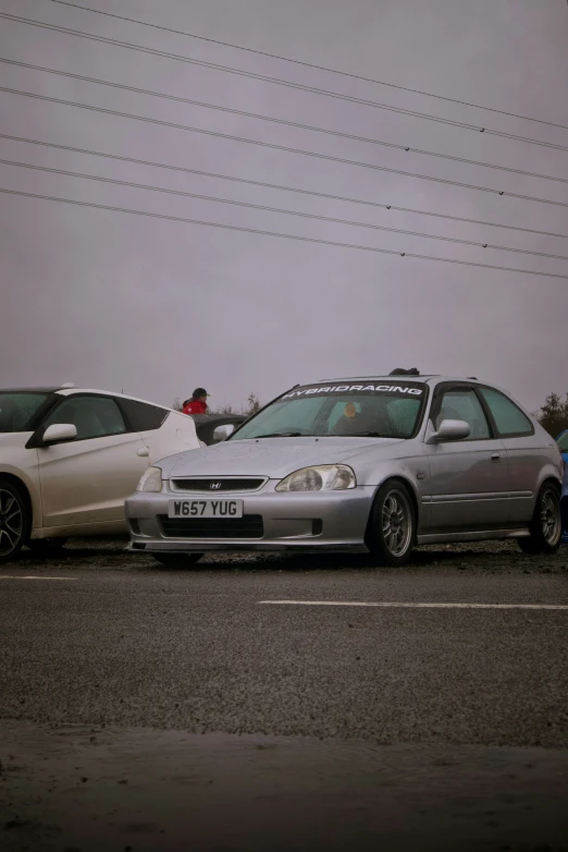 three cars in a parking lot next to each other