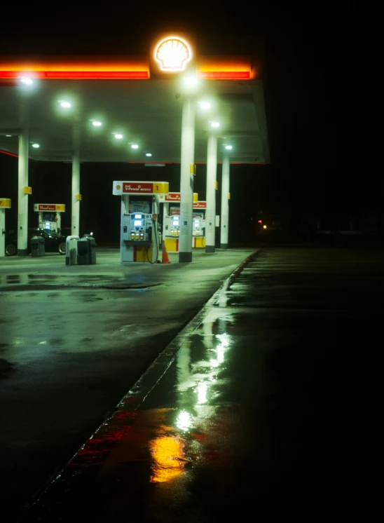 an empty gas station lit up at night