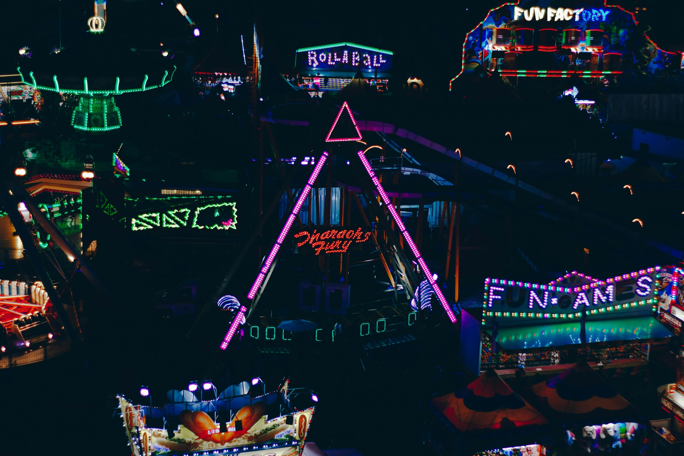 a carnival at night lit up with all kinds of lights