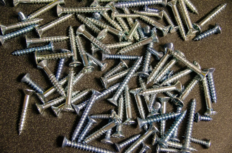 many screws that are laying on the floor