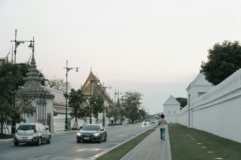 people are walking along a brick paved city street