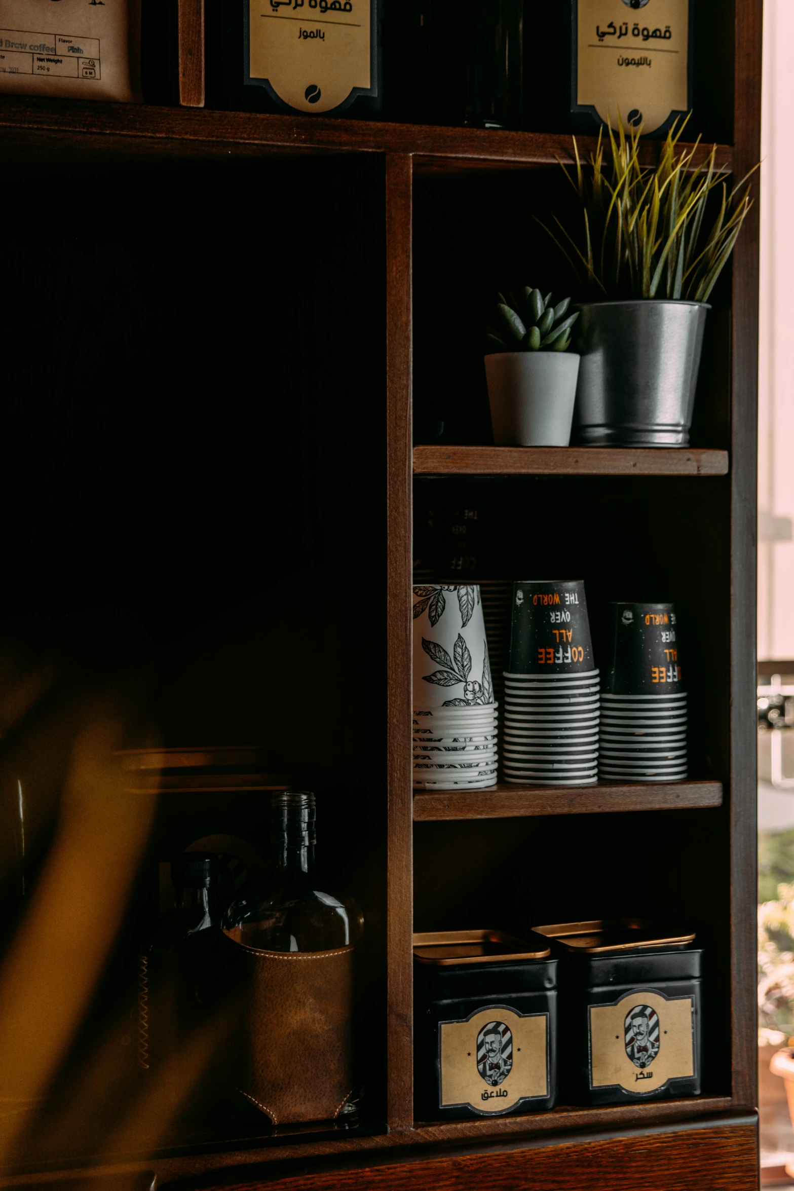 shelves filled with beer and drinks next to a window