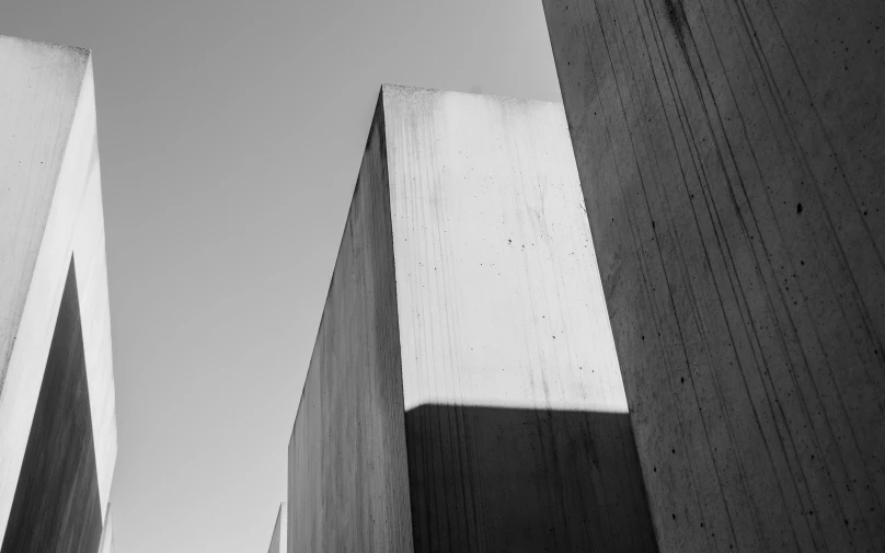 two concrete buildings against a blue sky