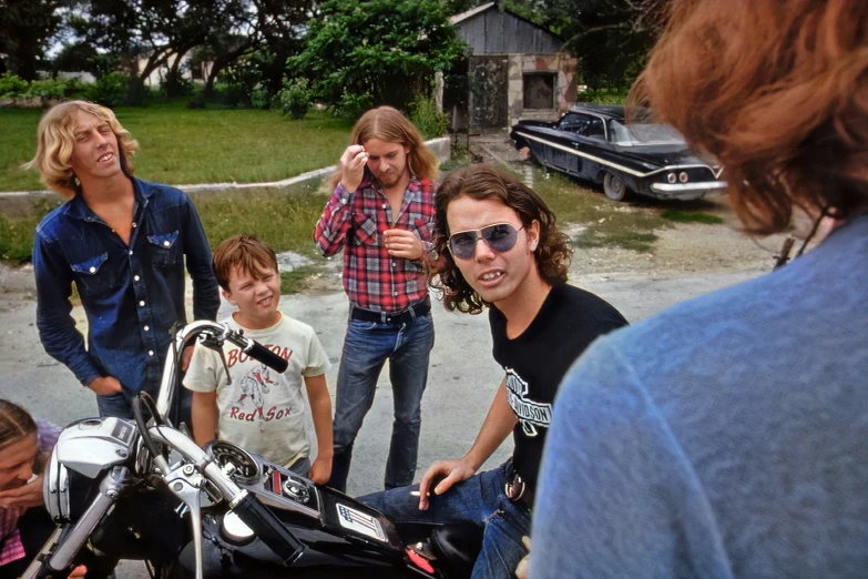 four adults and two children on a motor bike