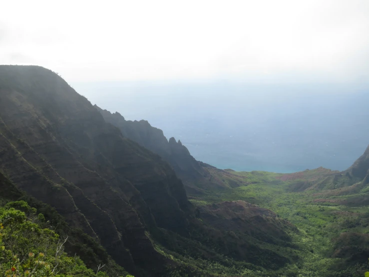 a scenic valley with mountains, rivers and a body of water