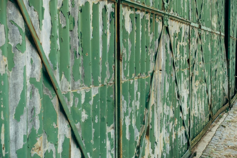 an old wall of peeling paint painted in bright green