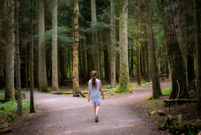 a girl in a dress running away from the camera