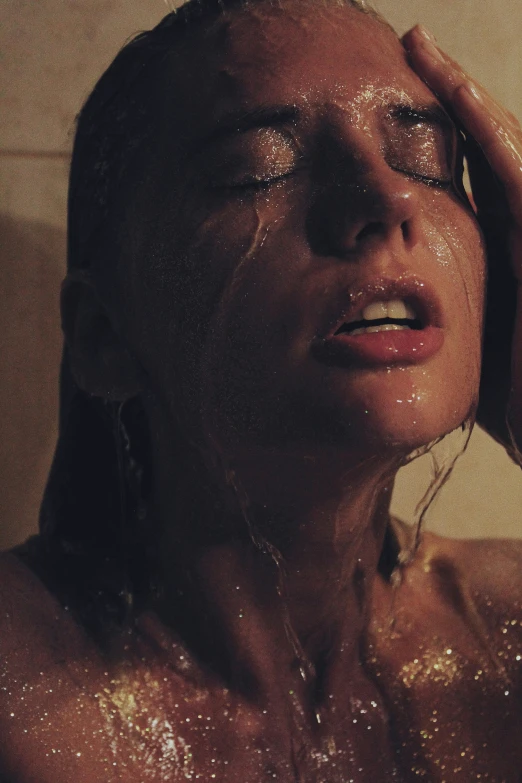 a woman getting her wet in the shower