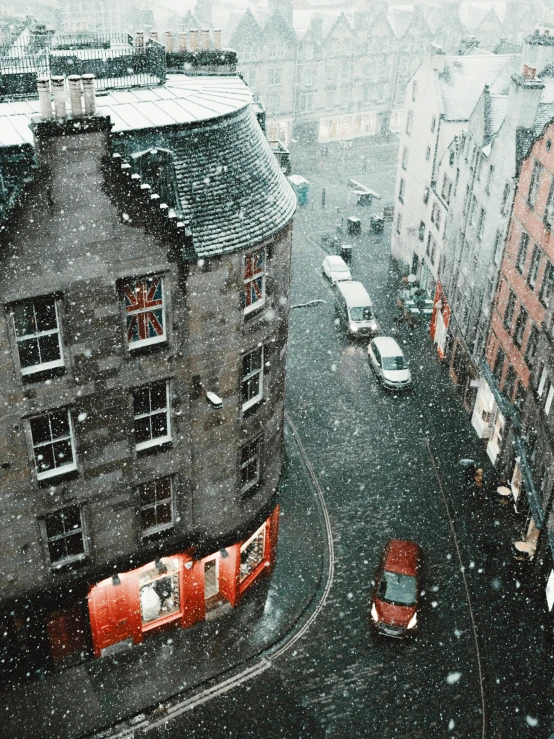 a street in the rain with red vanses on it