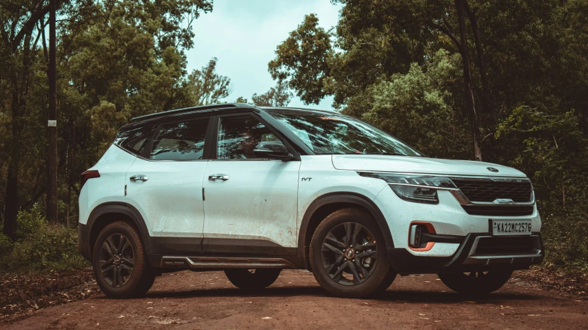 a white suv that is parked in the woods