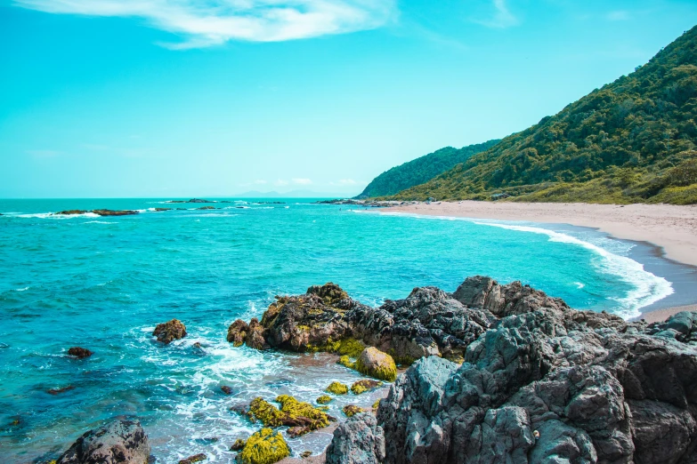 a view of a rocky beach and blue water