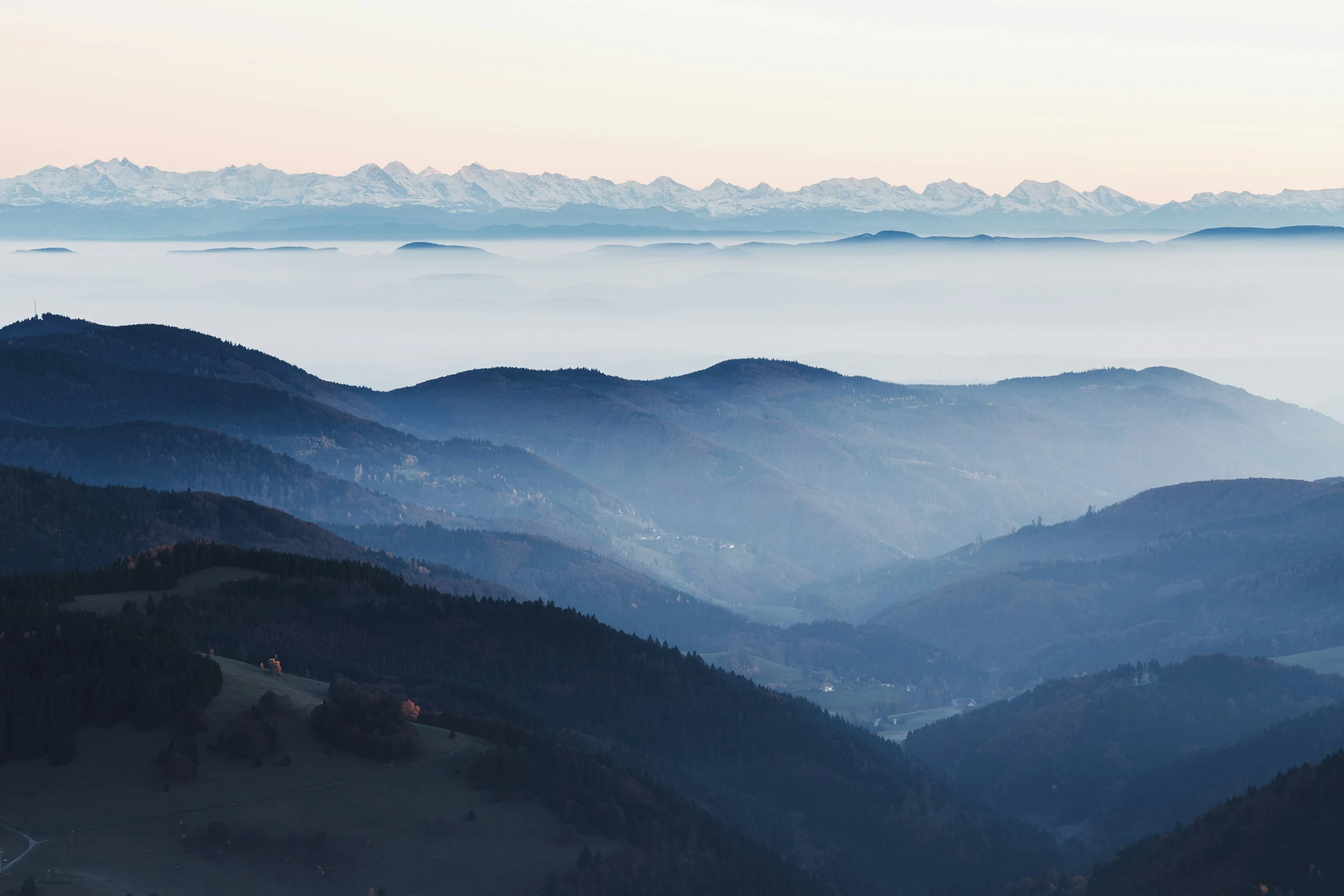 the view from a high mountain top over a valley