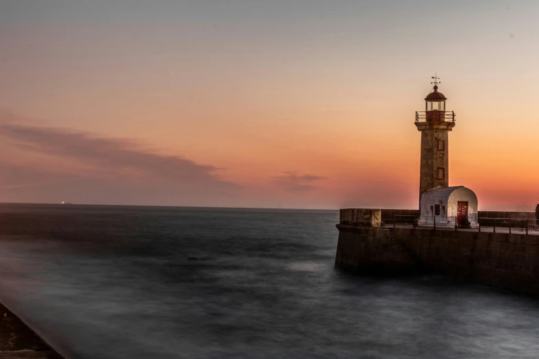 a lighthouse on the edge of an ocean