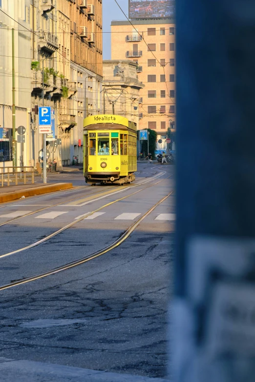 a tram is shown with yellow rails as it drives through the city