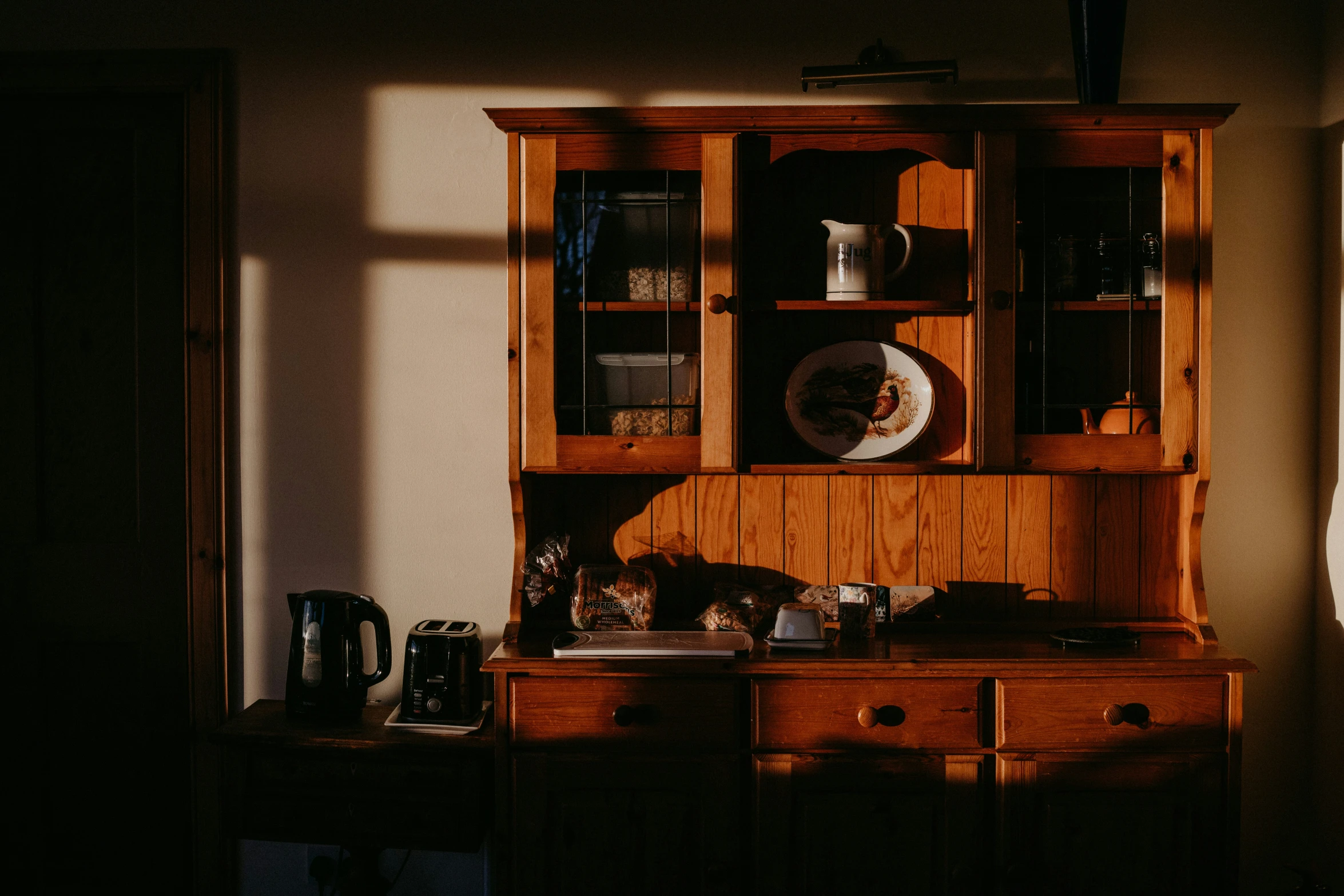 an old wood cabinet sitting inside of a living room