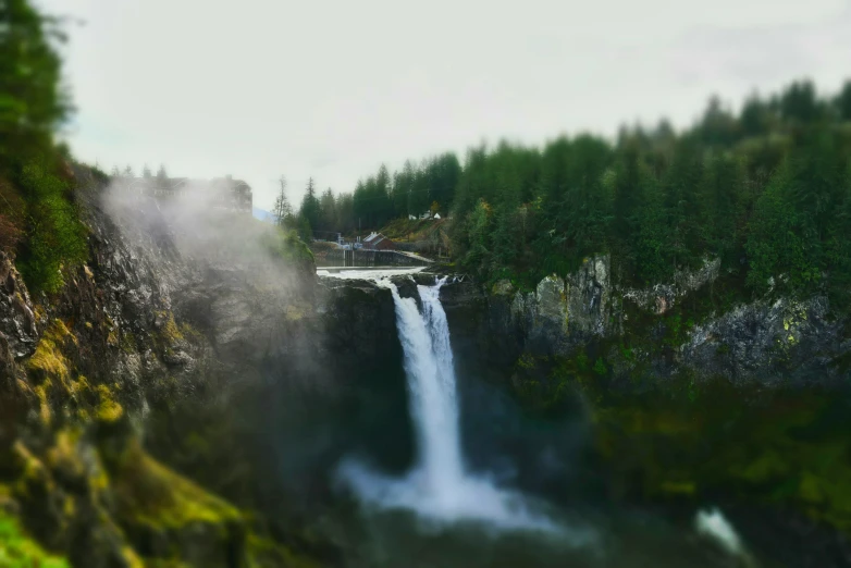 a man walking into a very tall waterfall