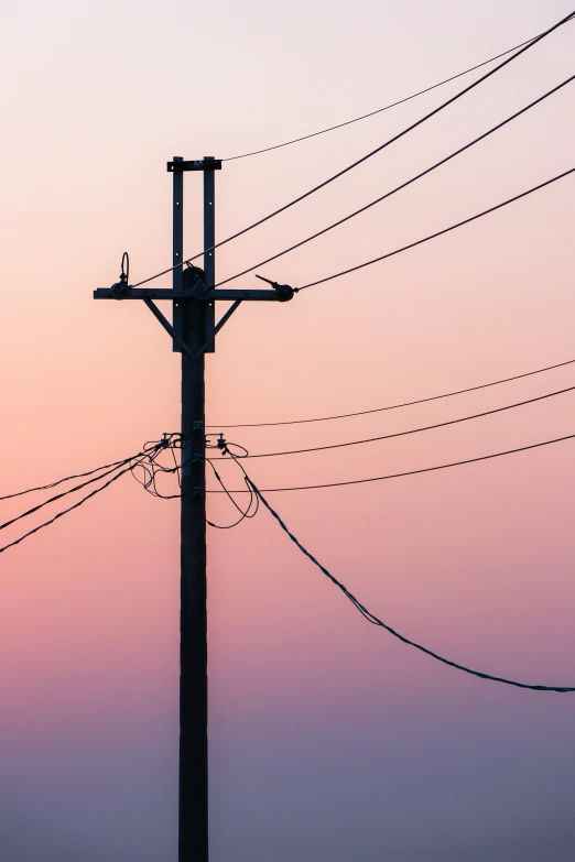 a sunset sky is seen with power lines