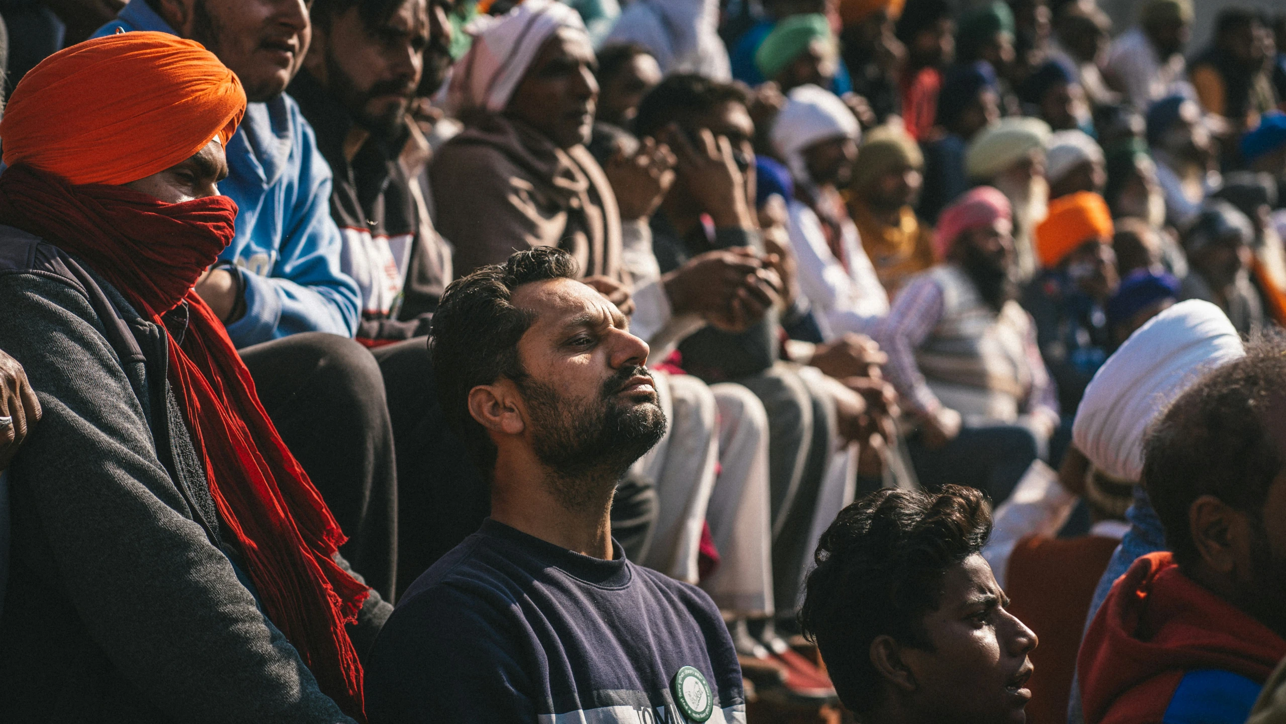 a crowd of people with their heads tilted