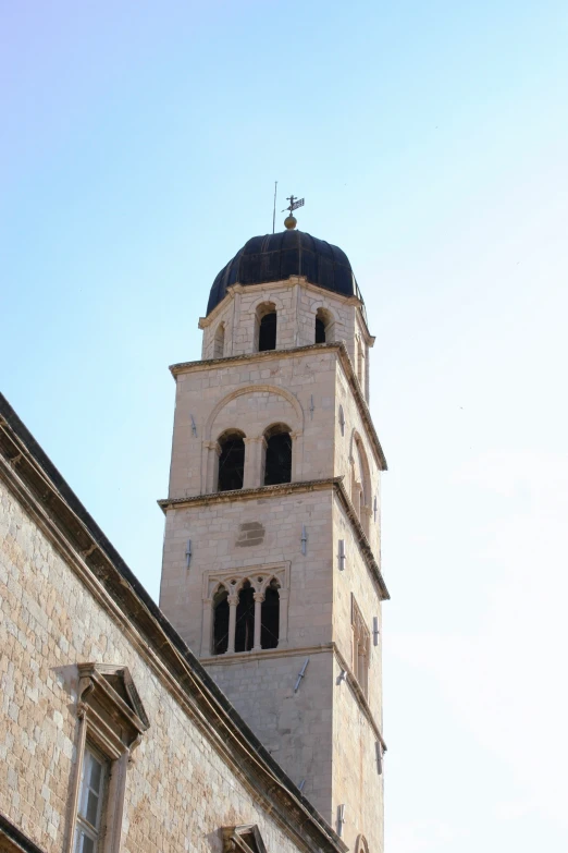 a tall tower in the distance with two clock faces