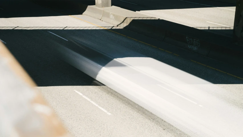 a skateboarder jumping up over the curb of a street