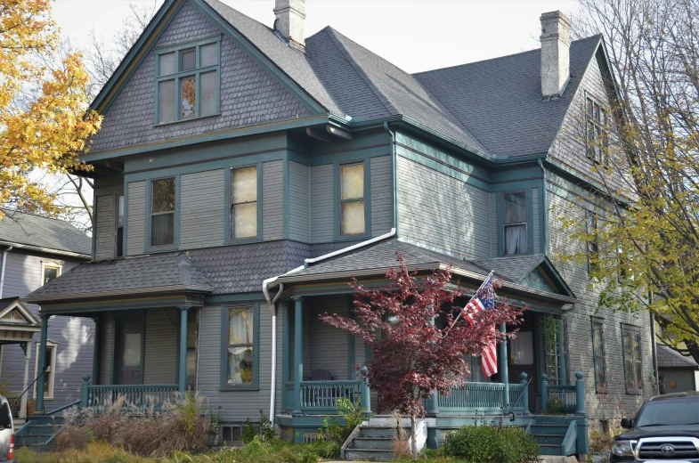 large victorian house with a flag hanging from the roof