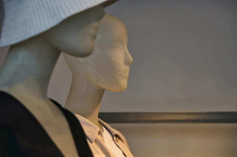 a mannequin dressed in clothes and hats