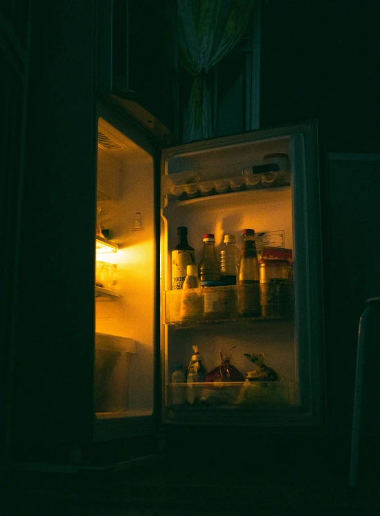 a refrigerator with the door open at night