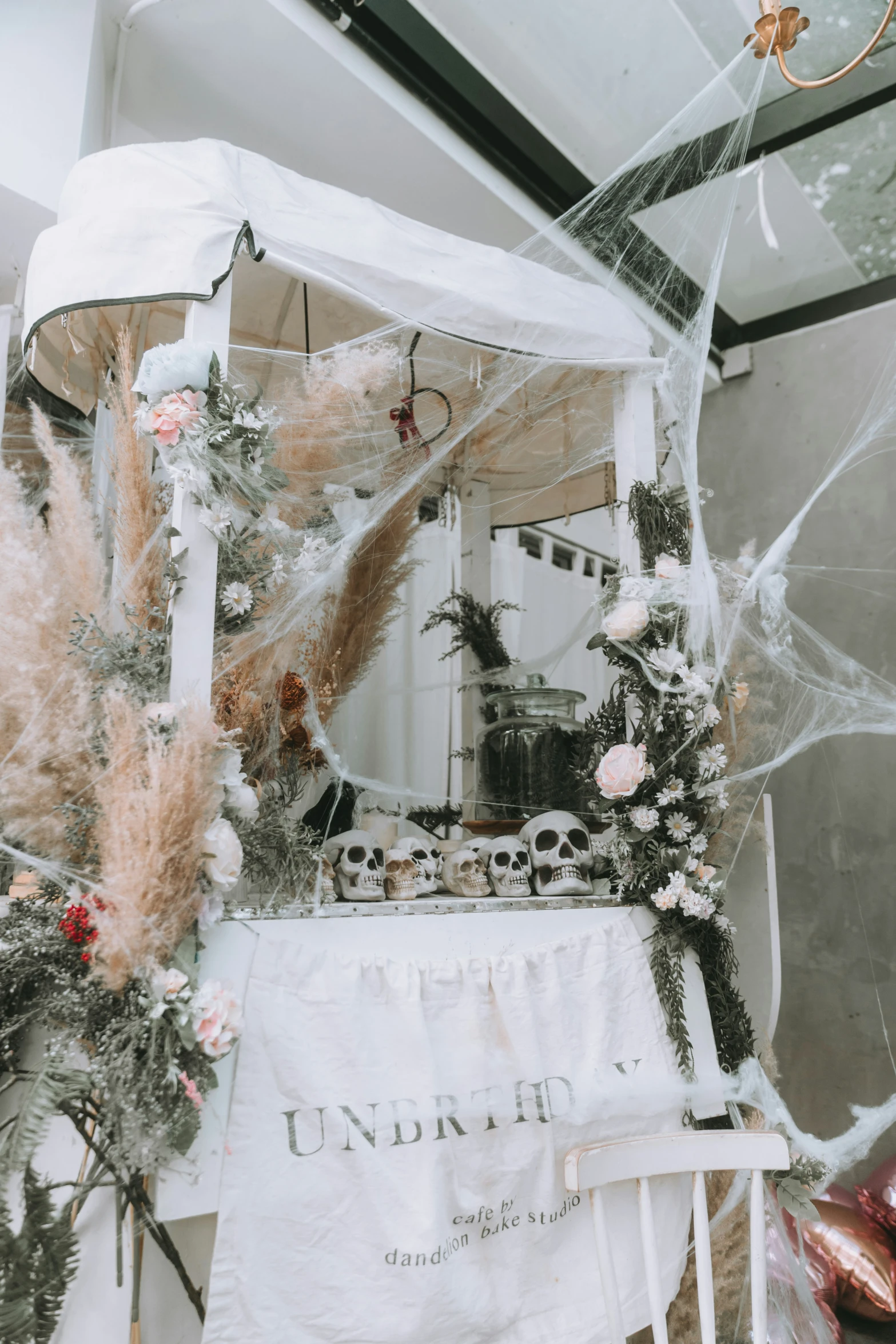 the wedding dress on display is covered by flowers and leaves