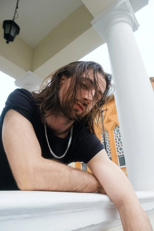 a man sitting on top of a porch