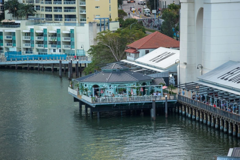 the view from above of an oceanfront restaurant with its dock and water taxi