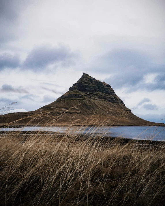 there is a tall mountain by the water