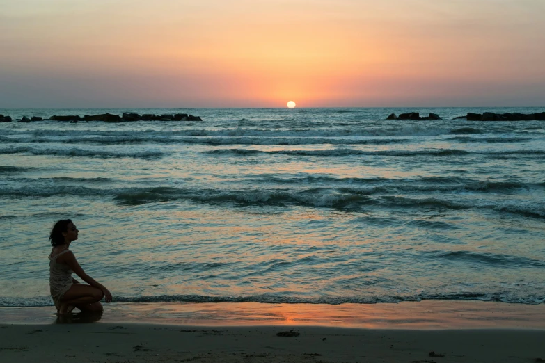 a  sitting on the beach watching the sunset