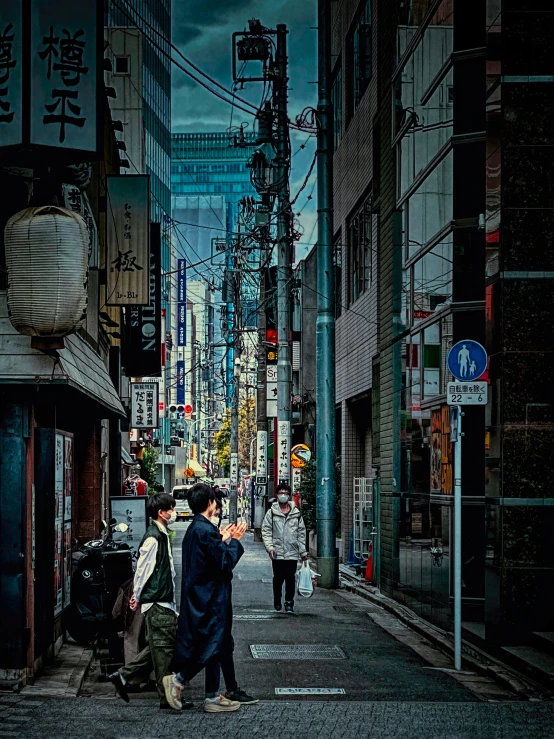 two young people are standing on the street corner