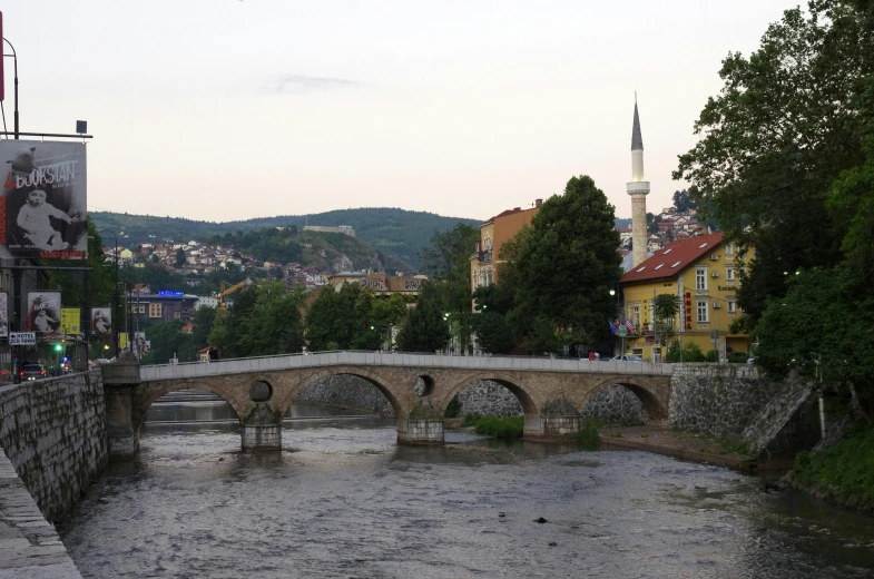 a large stone bridge with a view of buildings