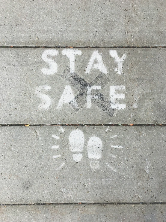 a sidewalk with street signs painted on it