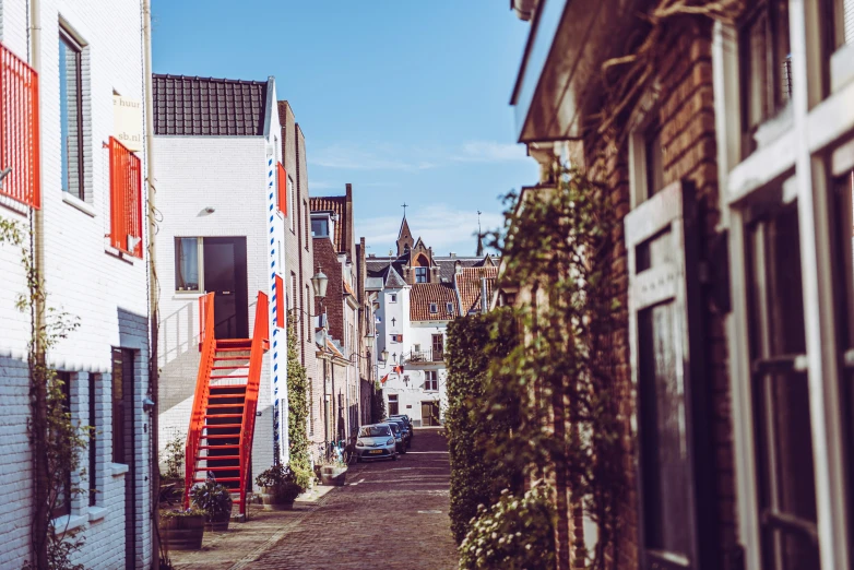 narrow street scene with buildings and stairs in background